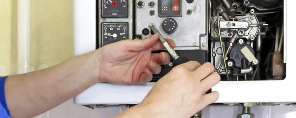 Heating repair technician adjusting boiler controls and components in Kissimmee, FL
