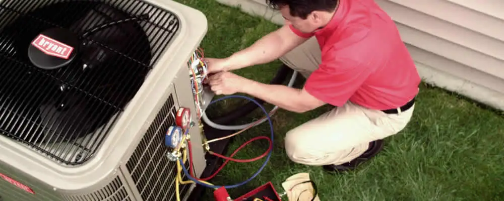 HVAC technician servicing an outdoor air conditioner unit in Kissimmee, FL